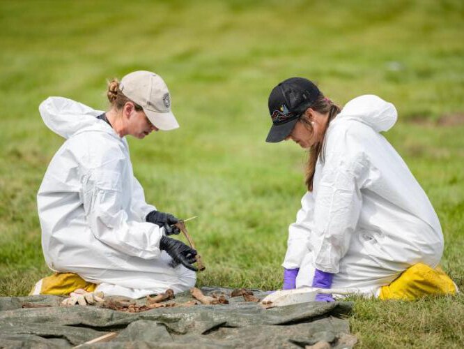 NMU Center for Forensic Science Director Jane Harris (left) with Dr. Carolyn Isaac of MSU, collaborating on the assessment of one of the victims.