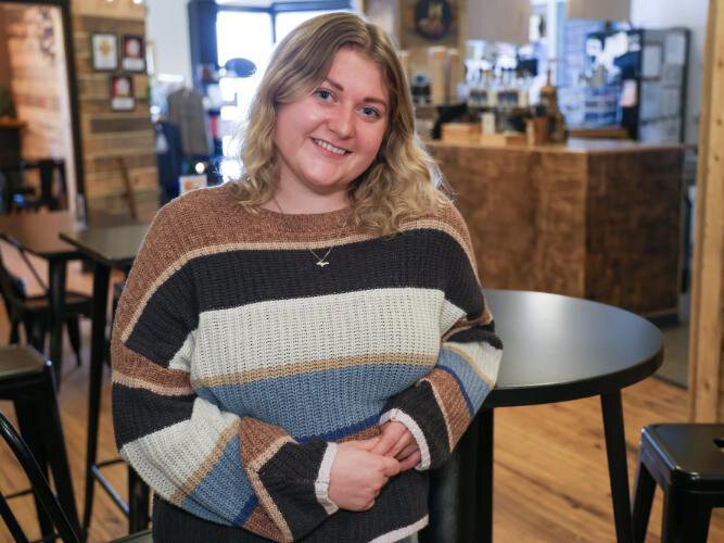 Shaylee Menhennick, a U-M graduate, stops for a coffee at Campfire Coffee on a recent trip home to Negaunee.
