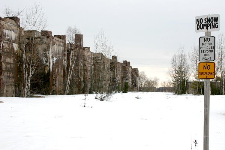 Parts of a long-crumbled structure next to a park. 